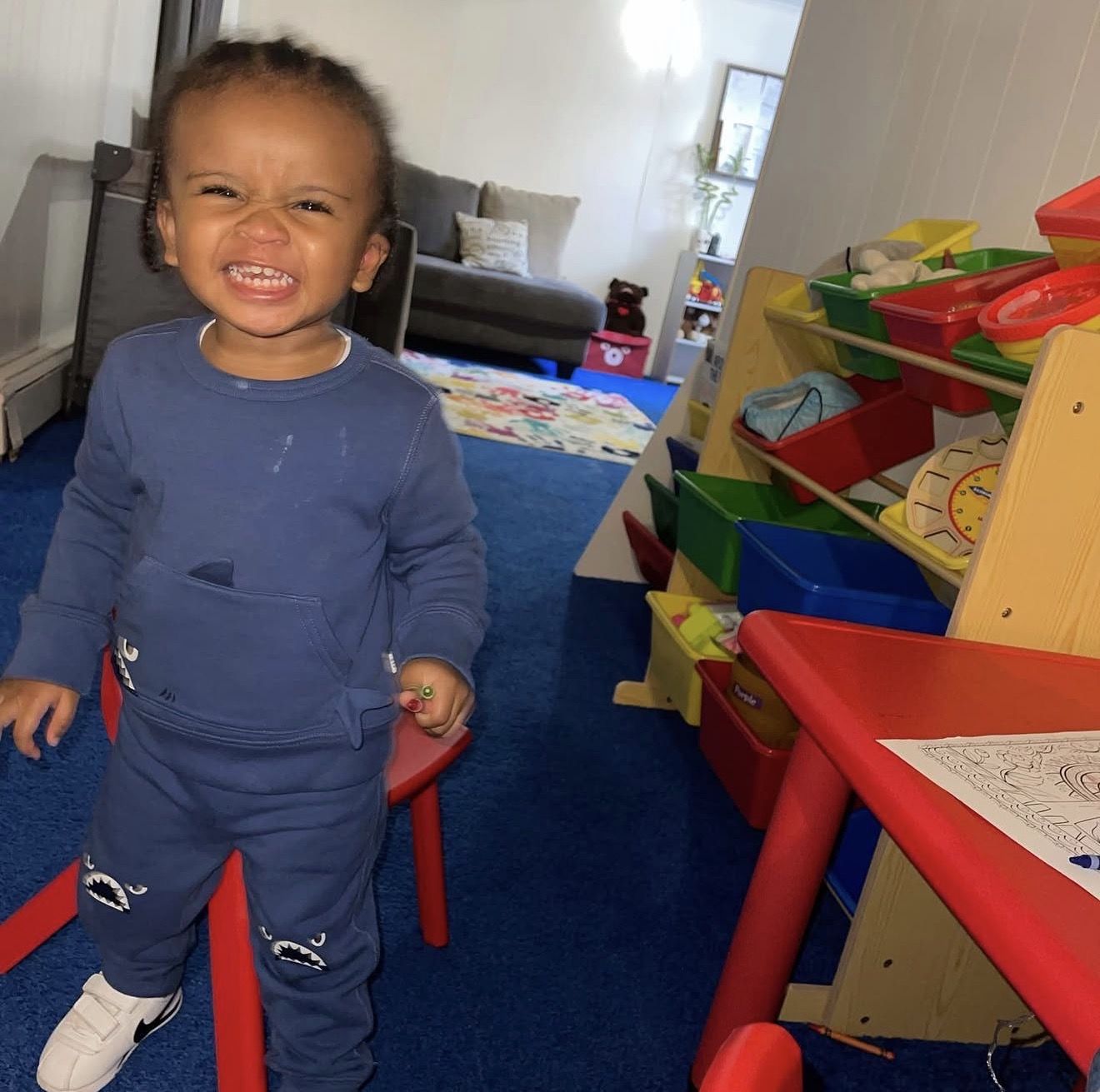 Toddler standing at a musical learning walker