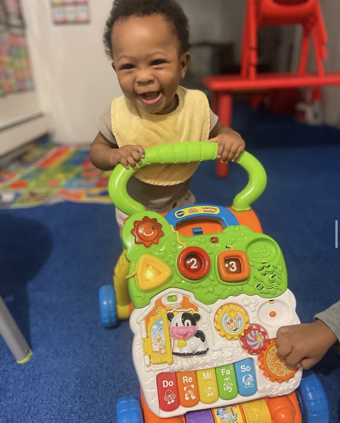 Baby playing with a musical learning walker